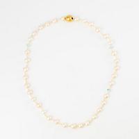 Ole Lynggaard clasp in 18K gold with a necklace of cultured freshwater pearls.