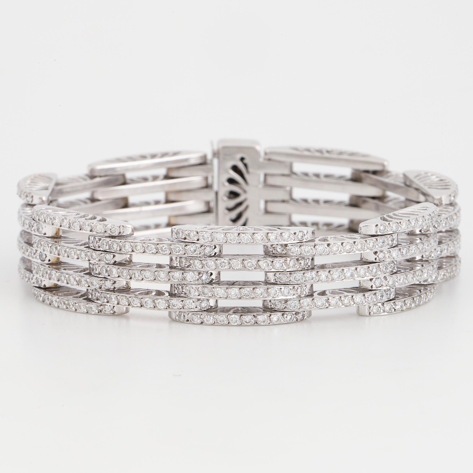An 18K white gold bracelet set with round brilliant-cut diamonds.