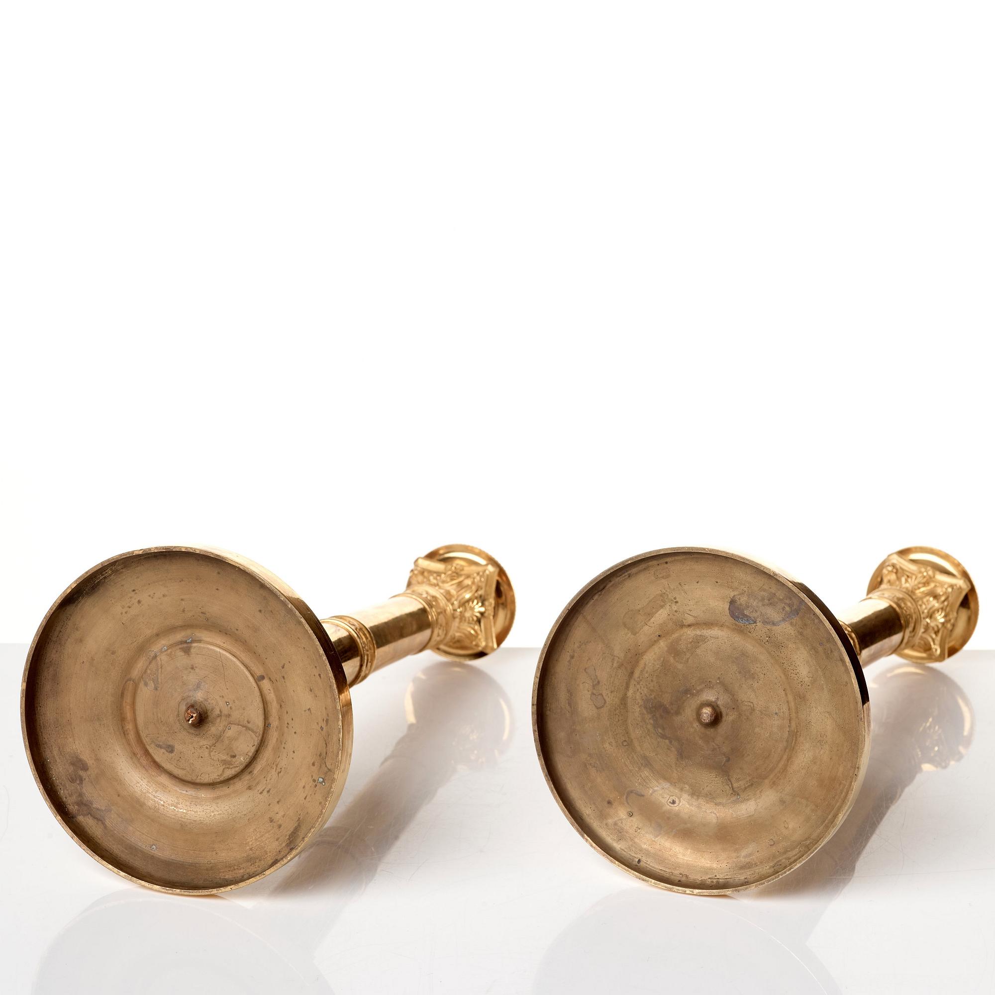 A set of four Empire presumably Russian candlesticks in gilded bronze.