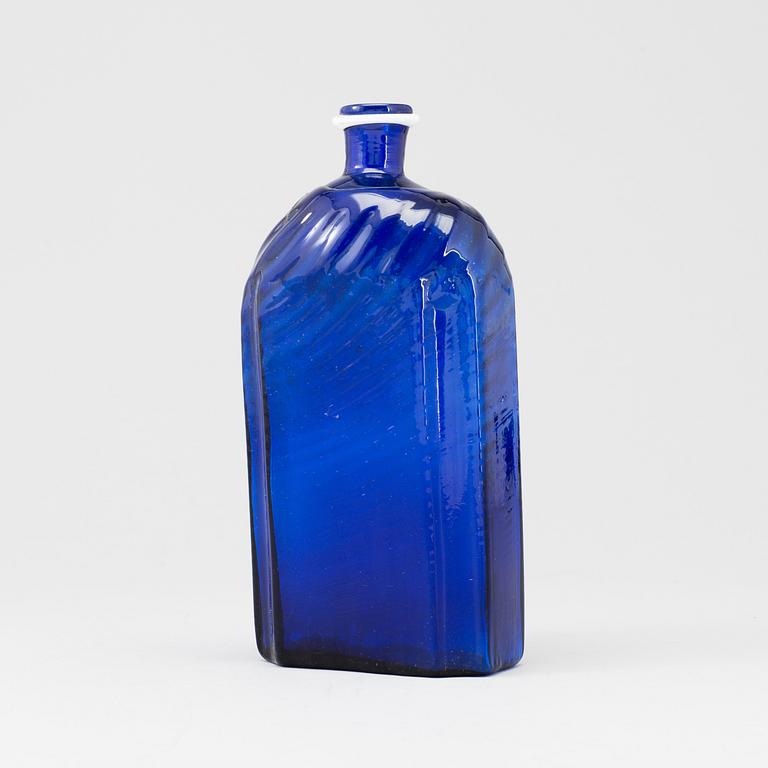 A late 18th or early 19th century glass bottle.