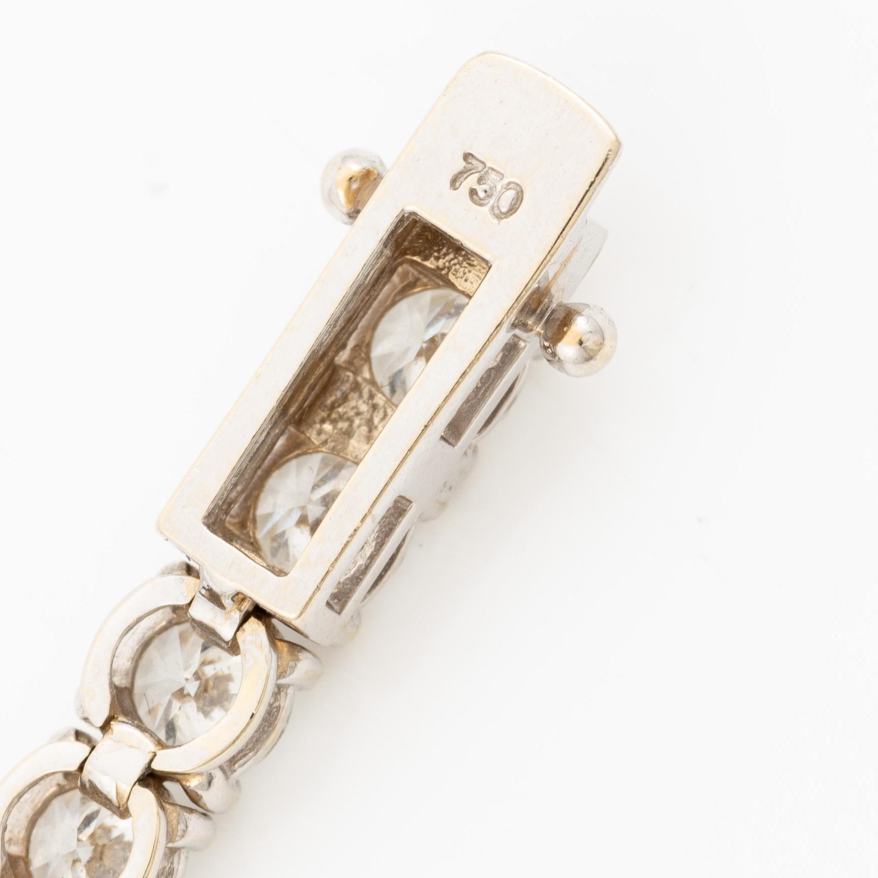 A tennis bracelet in 18K white gold set with round brilliant-cut diamonds total ca 11.50 ct, accompanied by GIA dossier.