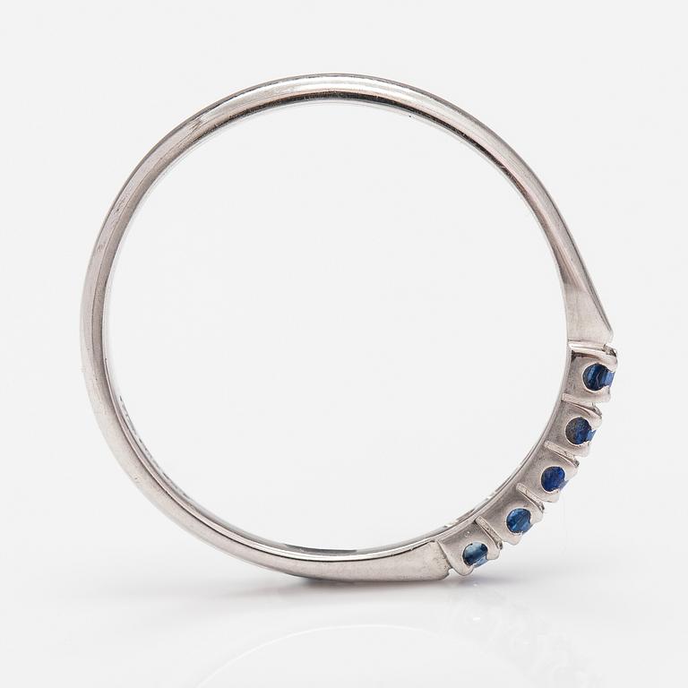 A 14K white gold ring with sapphires.