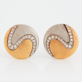 1023. A pair of Paul Binder earrings in 18K gold and white gold set with round brilliant-cut diamonds.