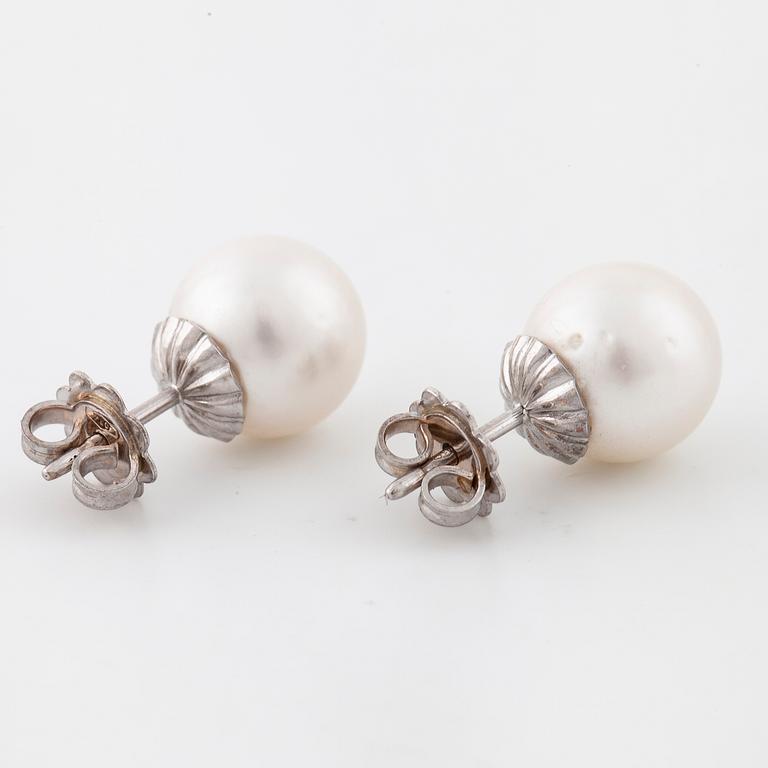 A pair of cultured pearl earrings.