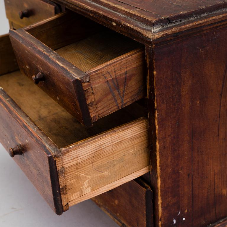 A 19th century miniature chest of drawers.