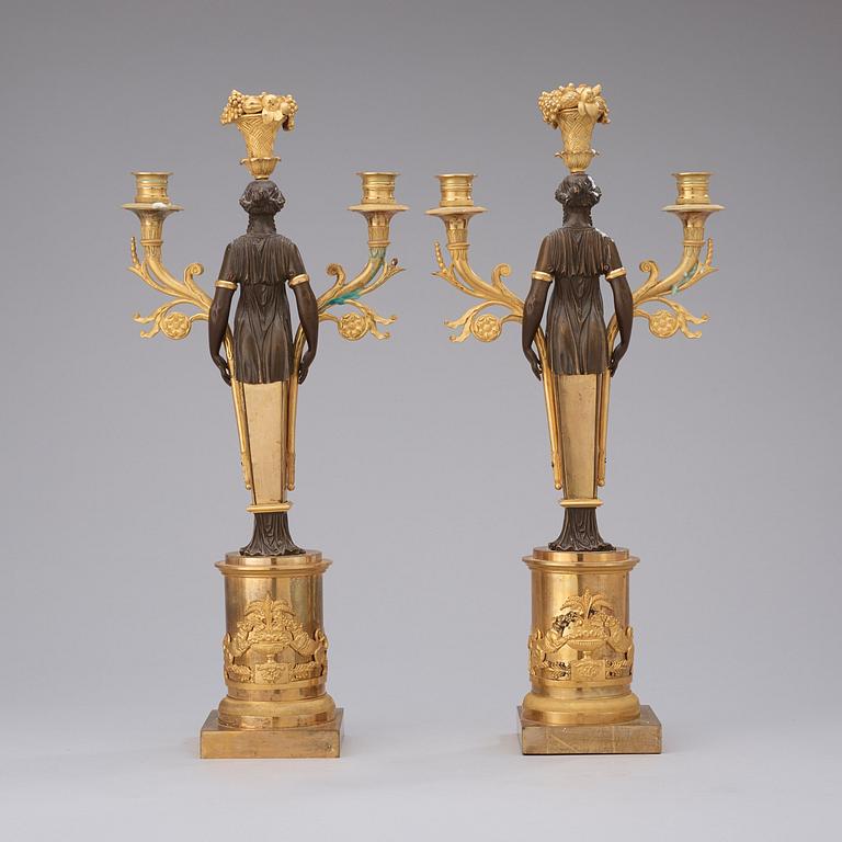 A pair of Empire early 19th century three-light candelabra.