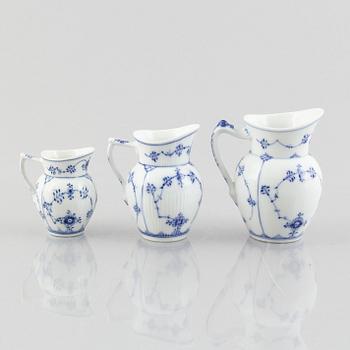 Three 'Blue Fluted Plain' / 'Musselmalet' porcelain jugs, Royal Copenhagen, 20th century.