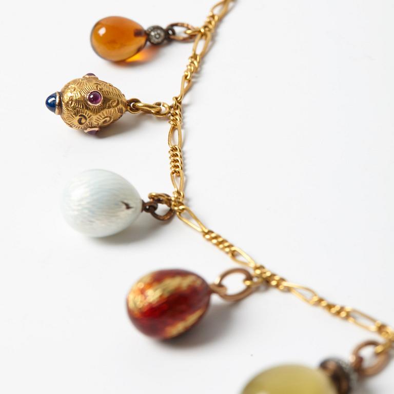 A FABERGÉ  GOLD Chain Necklace WITH 9 GOLD, ENAMEL ETC MINIATURE EASTER EGG PENDANTS, S.T PETERSBURG 1899-1908.