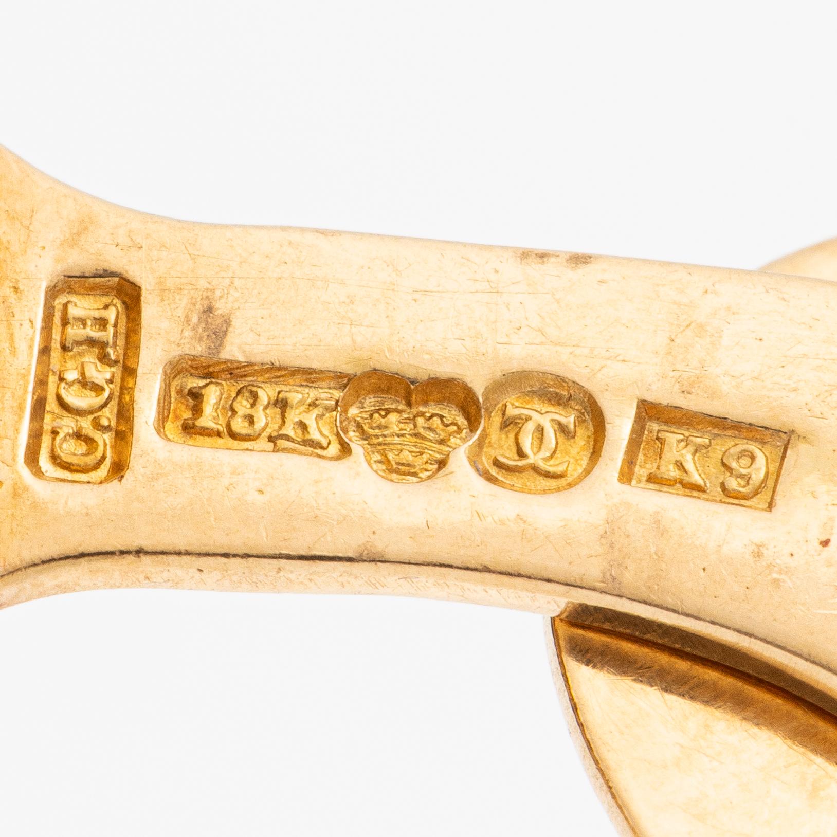 Ett par manschettknappar 18K guld med gröna stenar.