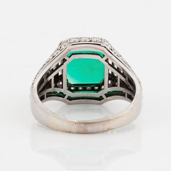 A Bulgari "Trombino" ring in platinum set with a step-cut emerald and round brilliant- and baguette-cut diamonds.