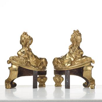 A pair of Louis XV fire dogs, France, mid 18th century, the design of the sphinxes attributed Nicolas Coustou 1658-1733.