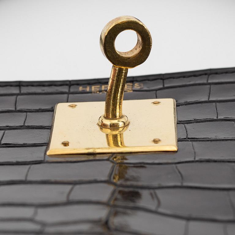 1962 black alligator 'Kelly' handbag by Hermès.