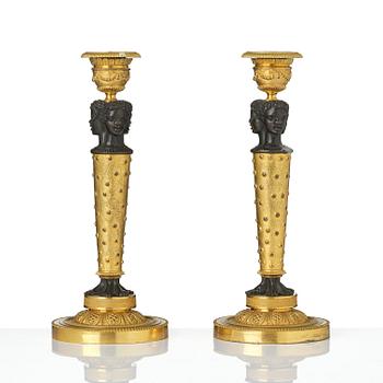 A pair of Napoleon III gilt and patinated bronze candlesticks, later part 19th century.