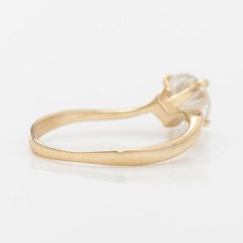 A 14K gold ring with brilliant cut diamond.