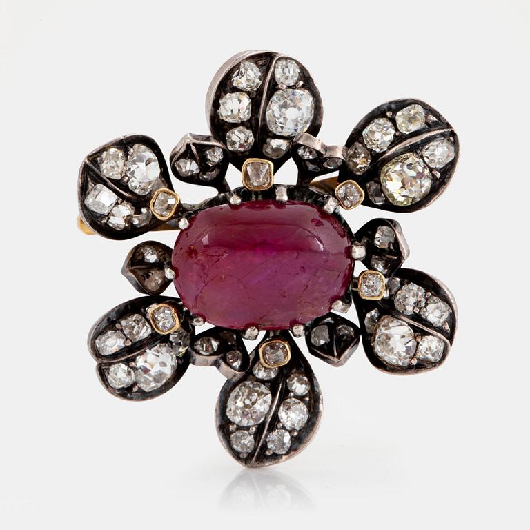 A brooch set with a cabochon-cut ruby ca 4.00 cts and old-cut diamonds.