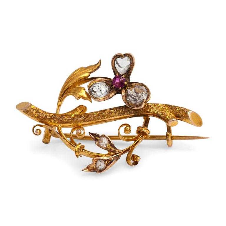 A 14K gold brooch set with rose-cut diamonds and a ruby.