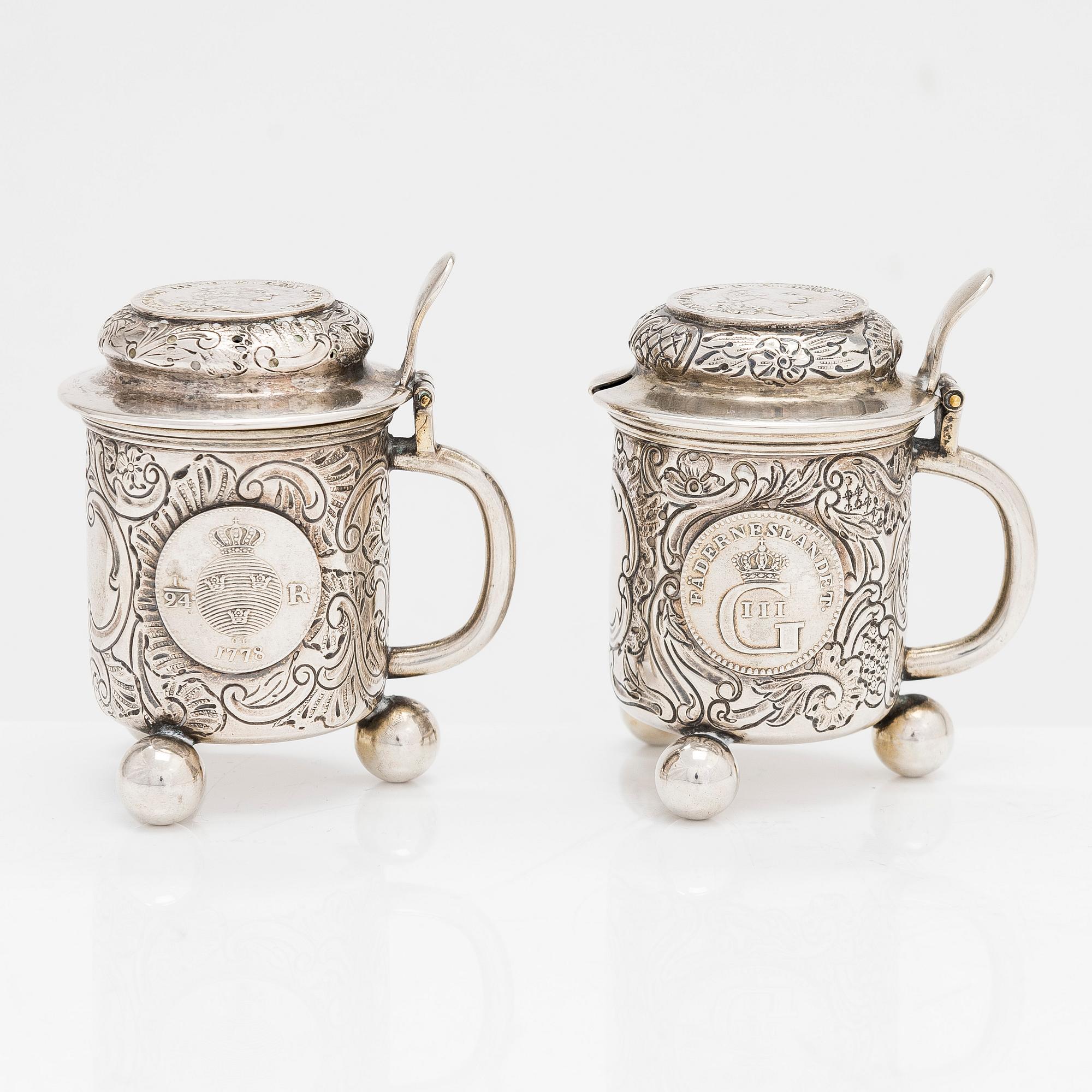 A pair of silver salt and mustard tankard,  C.G. Hallberg, Stockholm 1911 and 1914.
