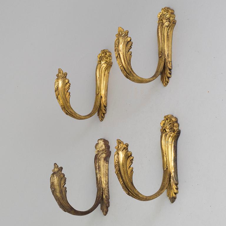 A SET OF FOUR BRONZE CURTAIN TIE-BACKS, 19th century.