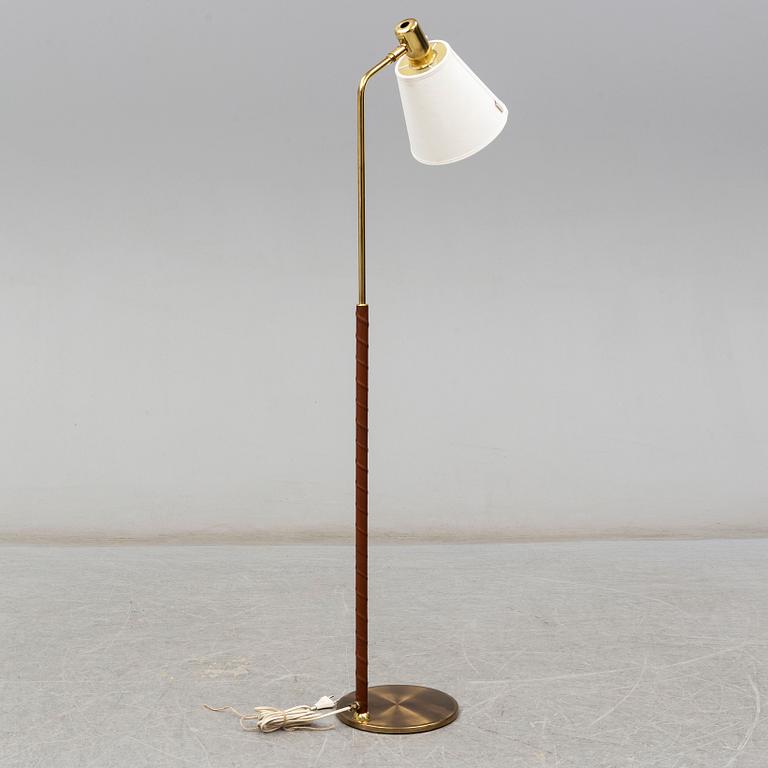 a brass and leather floor lamp from the second half of the 20th century.