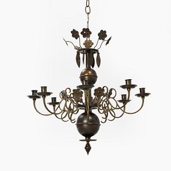 A Baroque style brass chandelier from around the year 1900.