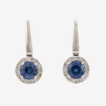 A pair of 14K gold earrings with faceted sapphires.