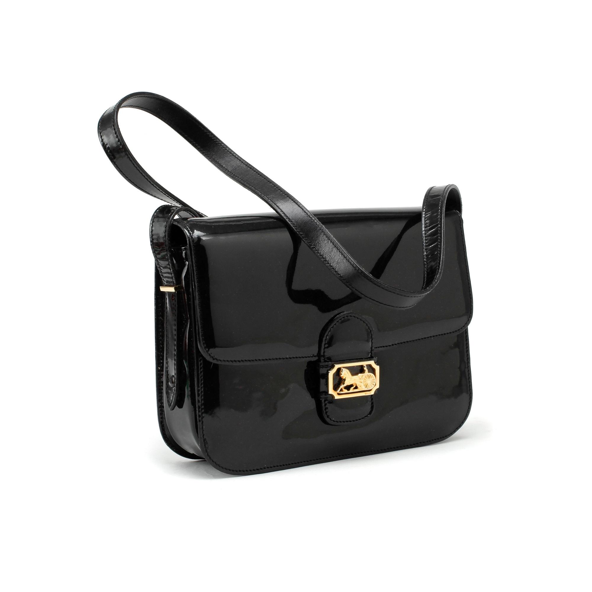 CELINE a black patent leather cross body bag. Bukowskis