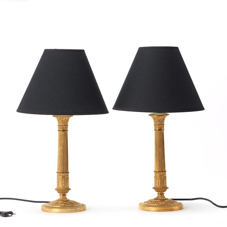 A pair of French Empire early 19th century gilt bronze table lamps/candlesticks.