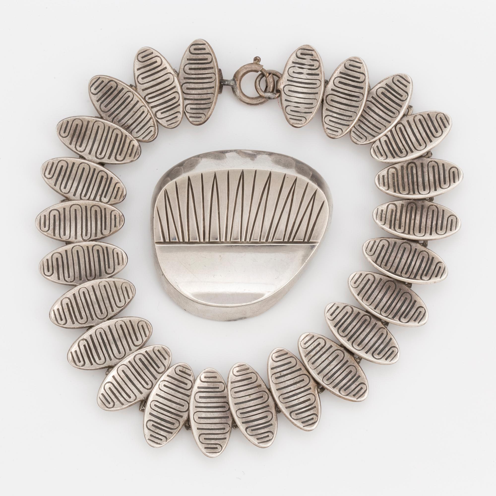 A 1950's silver bracelet and brooch.