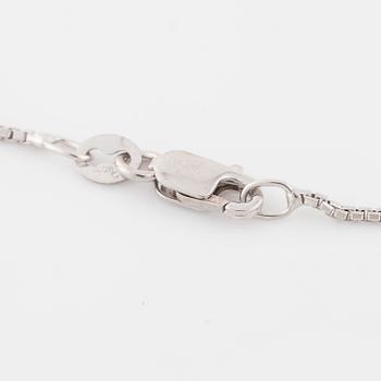 An emerald and brilliant cut diamond pendant.