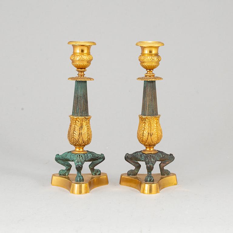 A 20th Century pair of bronze empire style candlesticks.