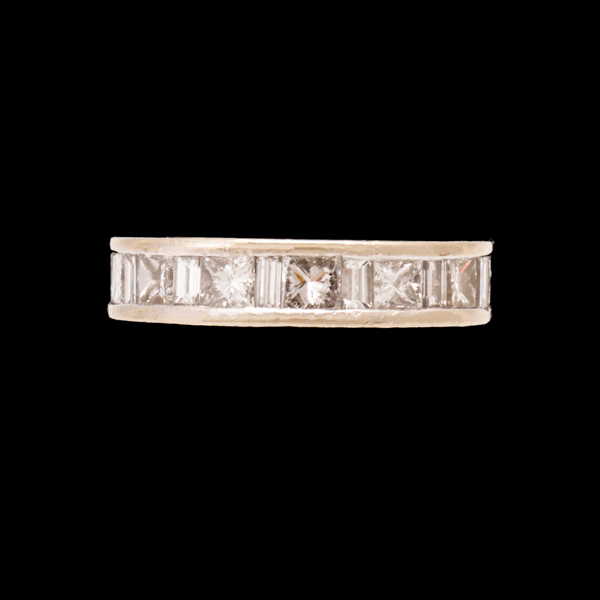 An 18K white gold eternity ring set with baguette and princess cut diamonds by Hartmann's Denmark.