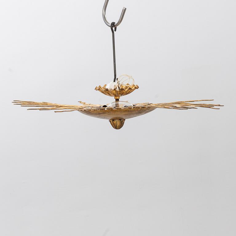 A ceiling lamp in the shape of the sun. Mid 20th century.