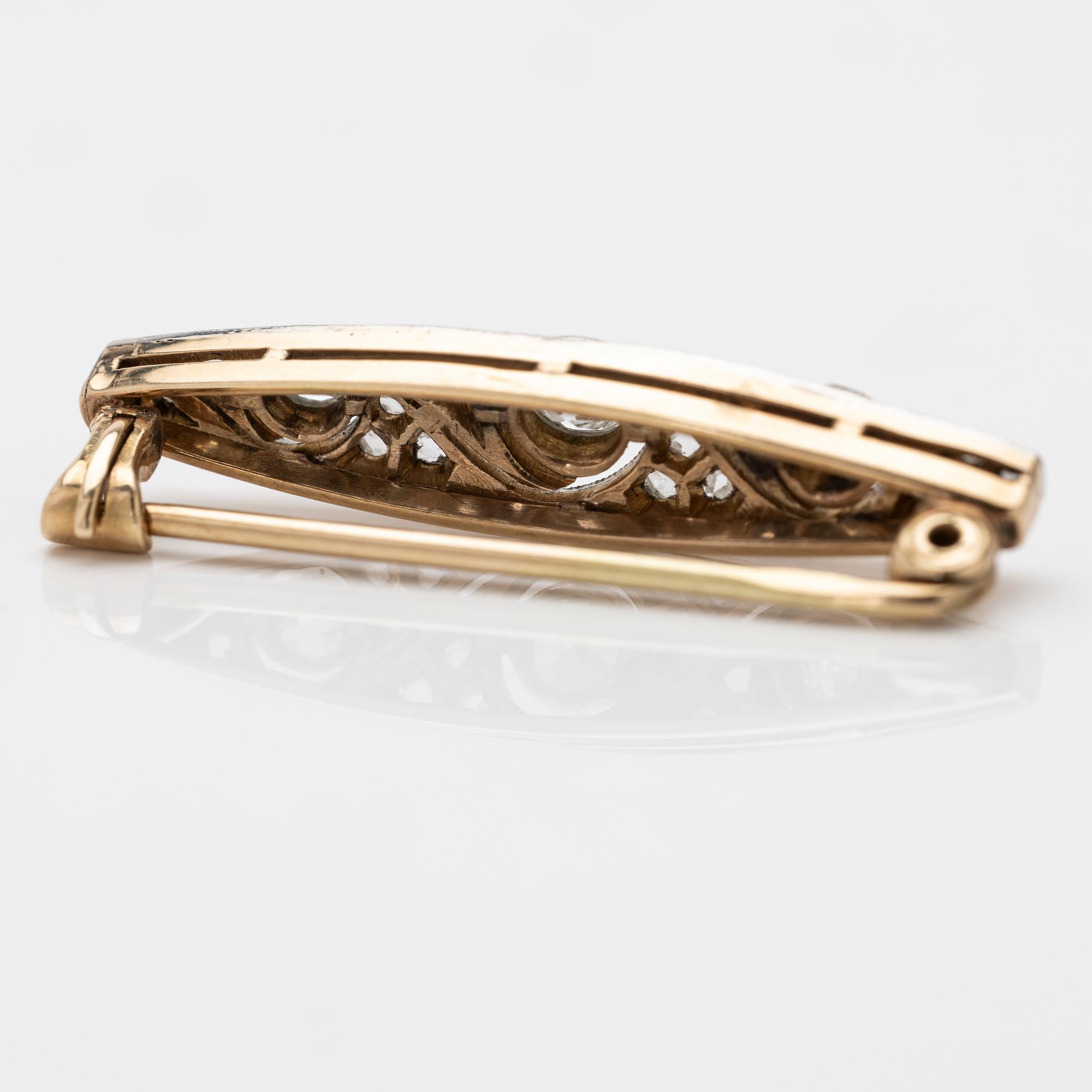 A 14K gold and platinum brooch with diamonds.