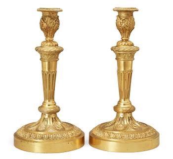 A pair of Louis XVI-style 19th Century candlesticks.
