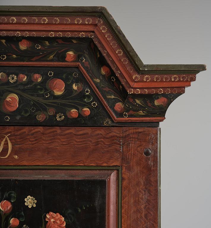A Swedish polychrome painted folk art corner cabinet, dated 1818.