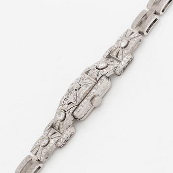 A bracelet/watch in platinum and 18K white gold set with old- and eight-cut diamonds.