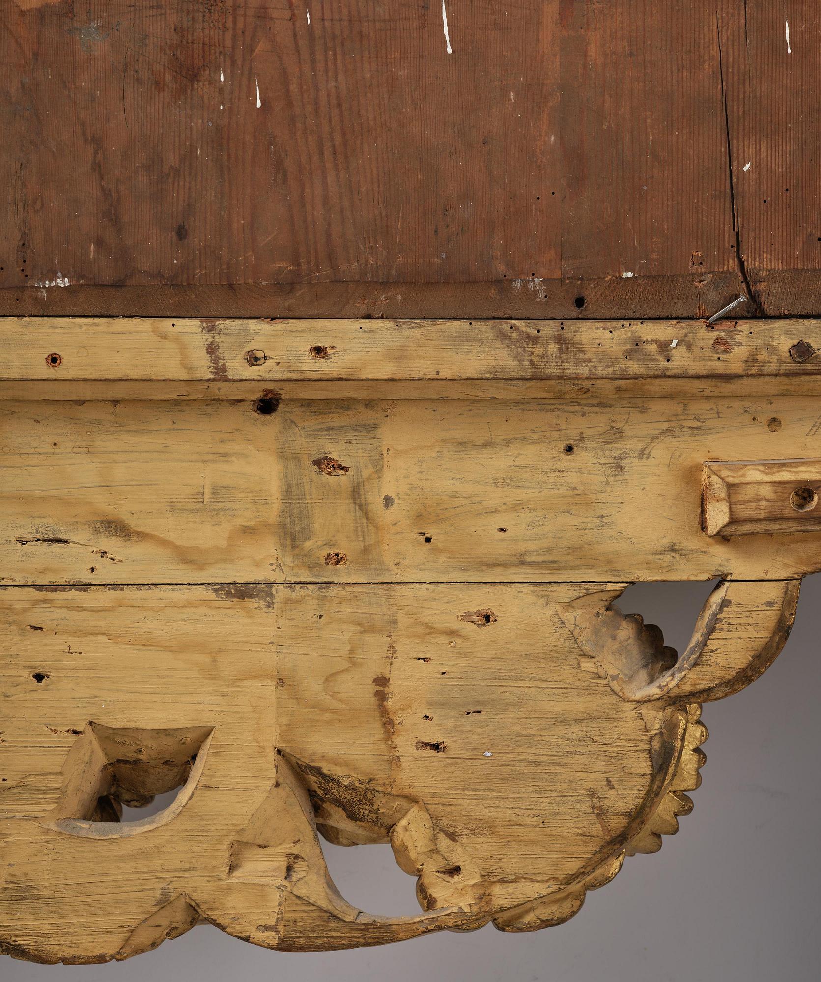 A presumably Dutch Louis XIV carved giltwood frame with mirror glass, in the style of Jean Le Pautre, late 17th century.