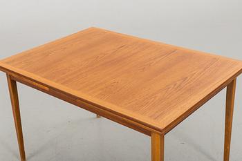 A TEAK DINNER TABLE.