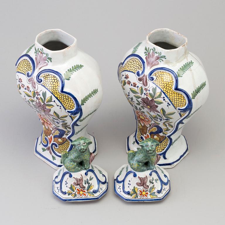 A pair of faience lidded urns, 18th/19th century.