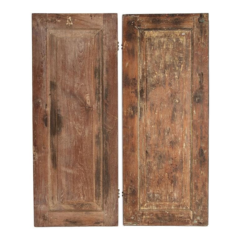 A pair of South East Asian carved wooden doors, presumably Java, 19th Century.