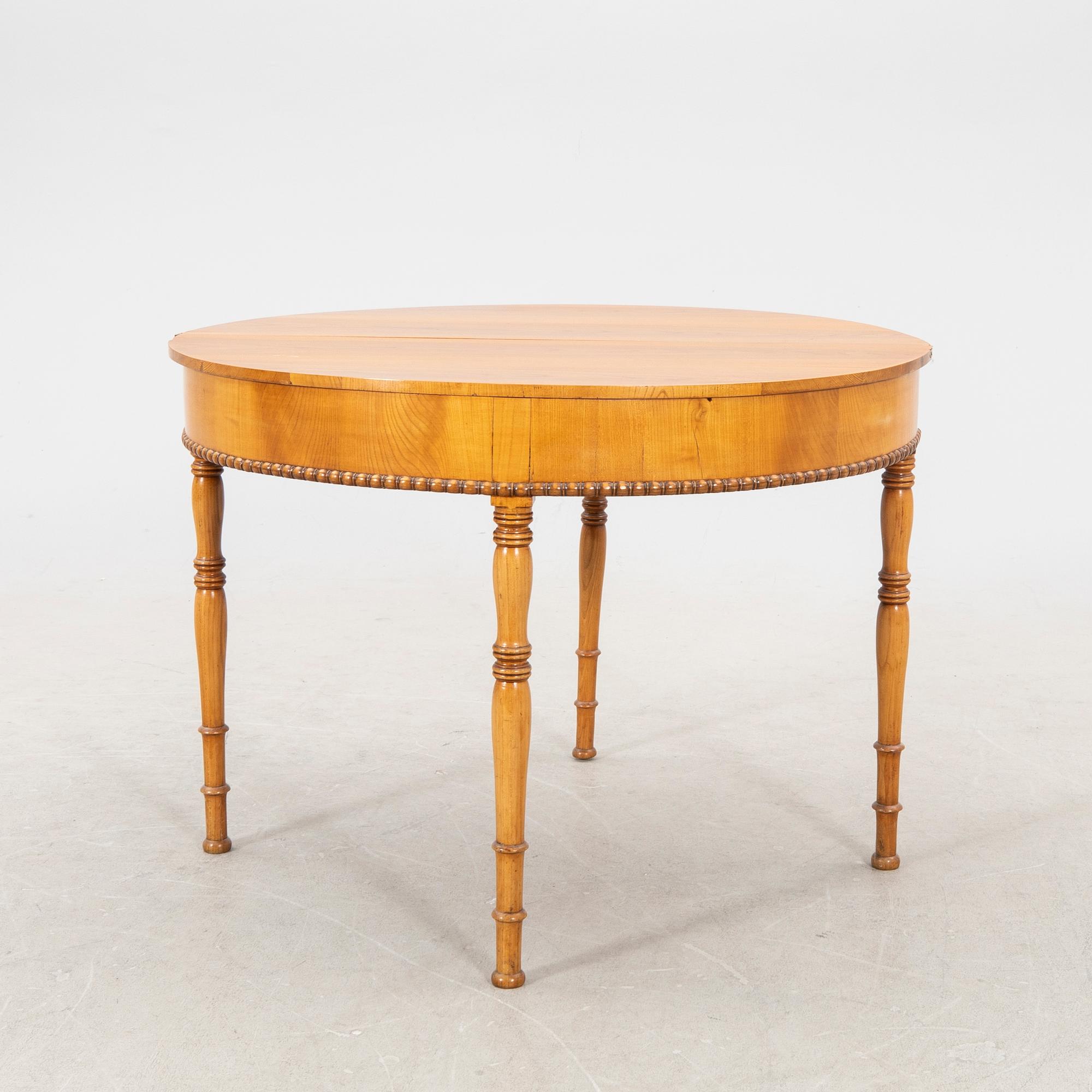 A kid 1800s late Empire birch game table.