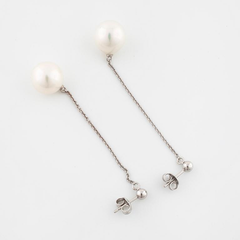 A pair of cultured pearl earrings.