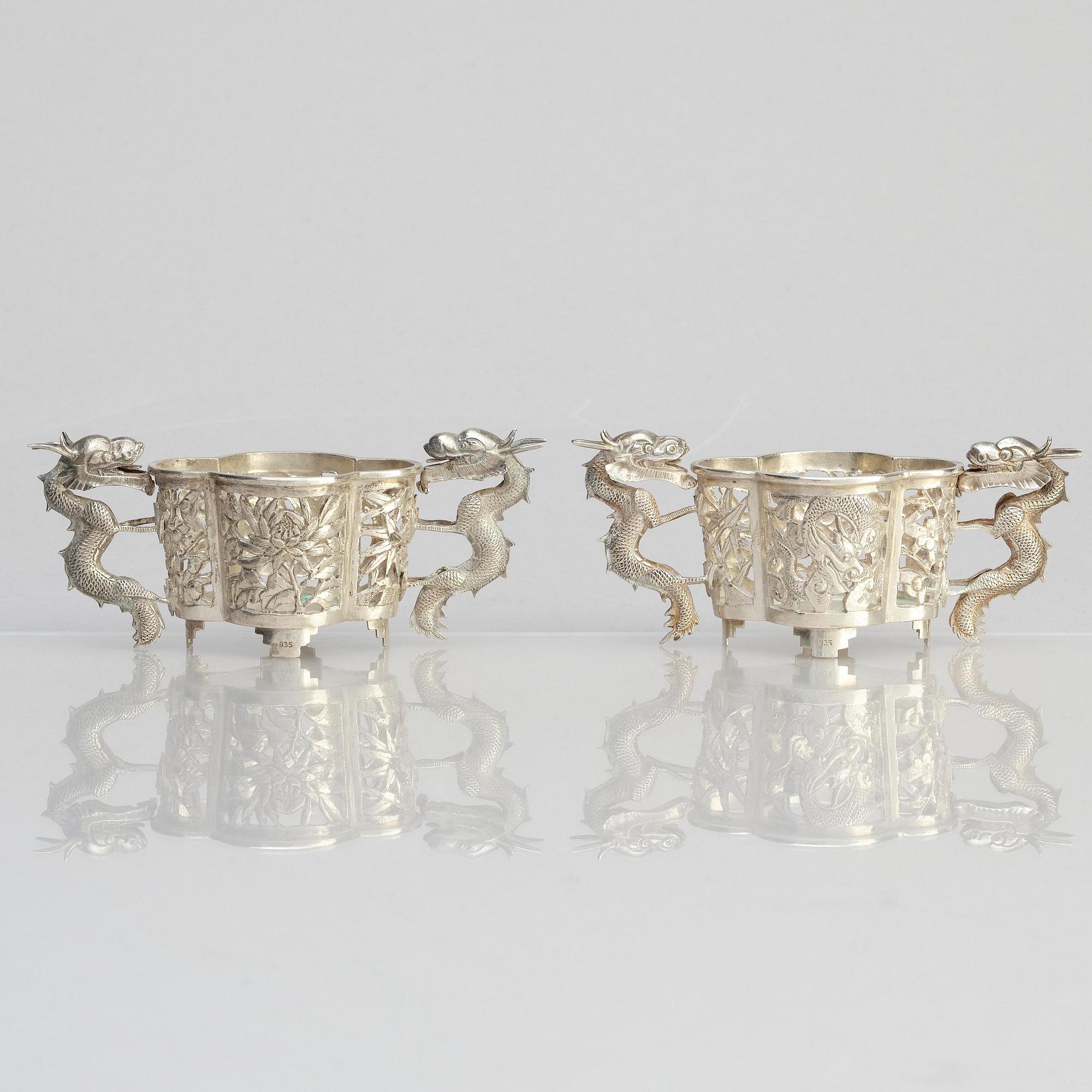 A pair of  Chinese silver cup holders/salts, 20th century.