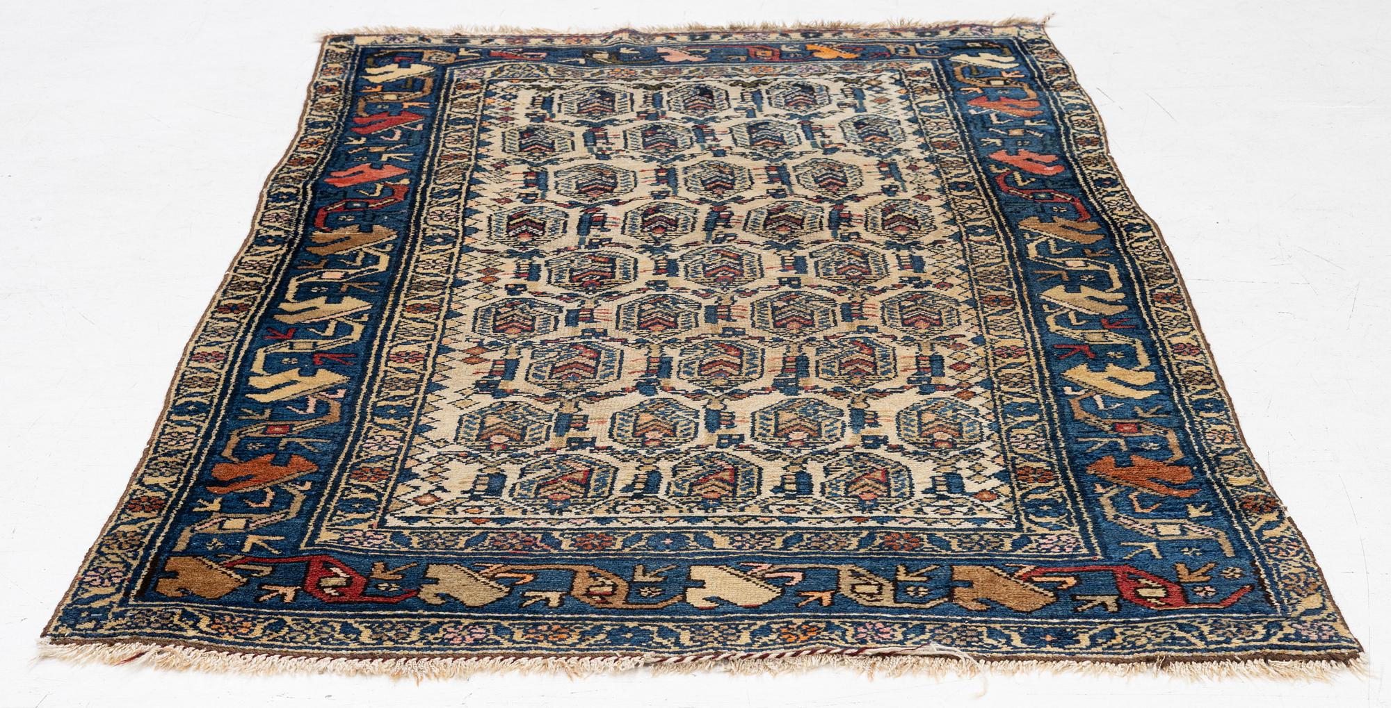 An antique Hamadan rug, c. 188 x 114 cm.