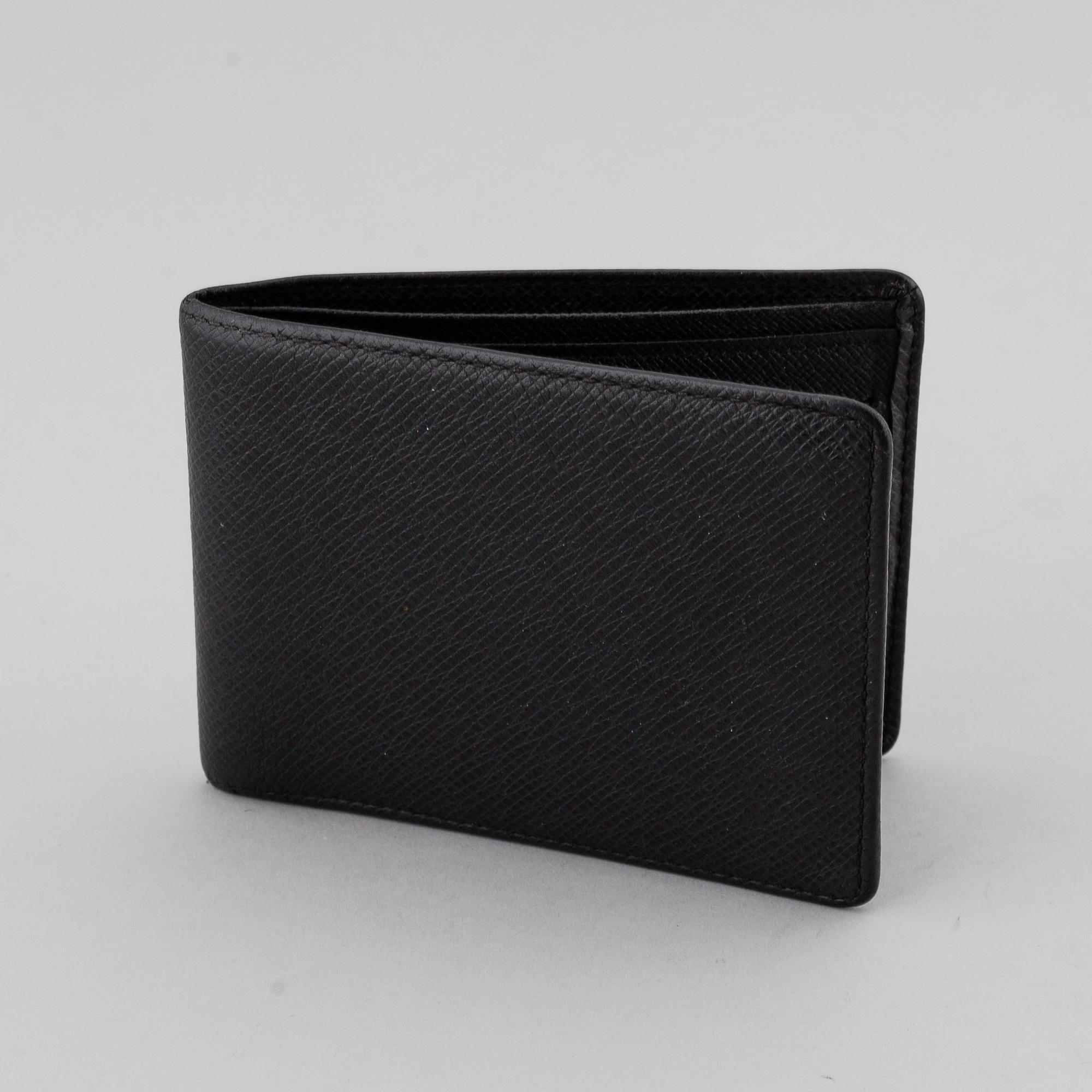 LOUIS VUITTON, black taiga leather wallet.