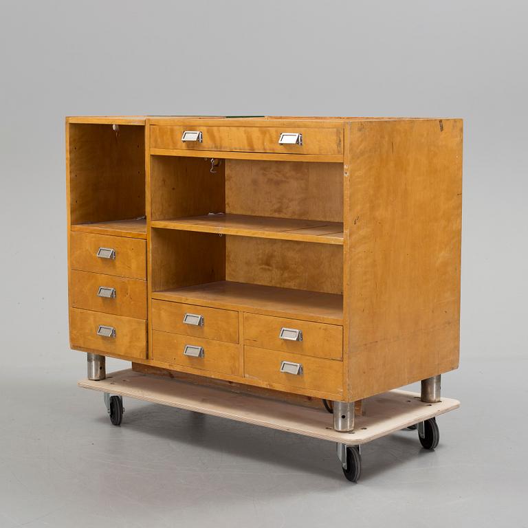 KÖPMANNADISK, 1900-talets mitt.