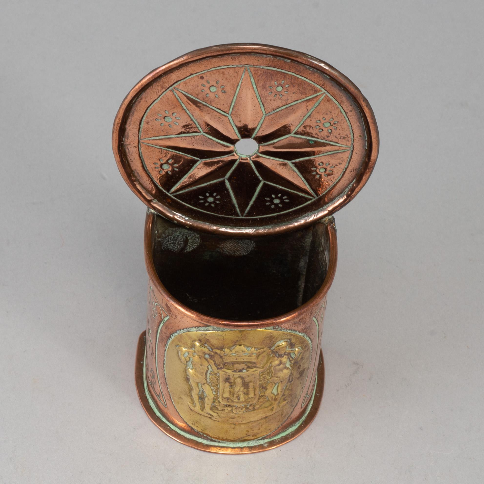 A 19th century brass and copper spoon holder.