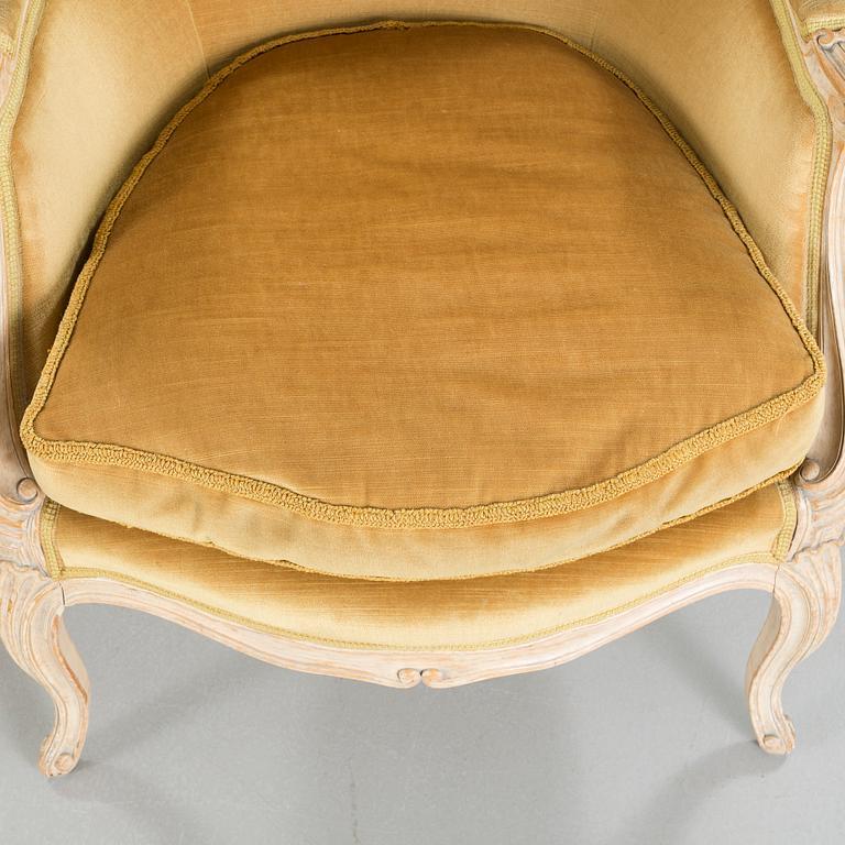 A pair of rococo style lounge chairs, first half of the 20th century.