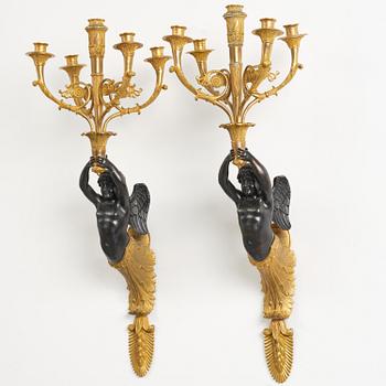 A pair of Napoleon III five-branch gilt and patinated bronze appliques.
