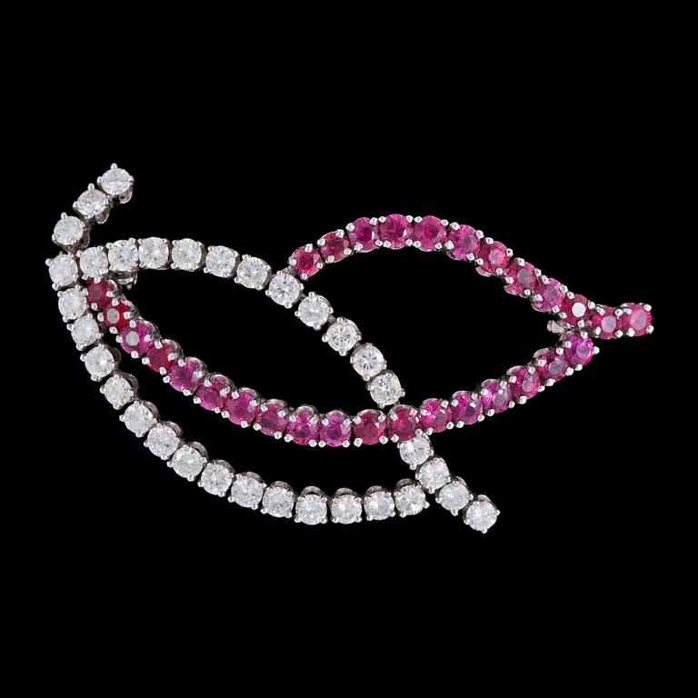BROSCH, runda fasettslipade rubiner och 33 briljantslipade diamanter, tot. ca 1.70 ct.